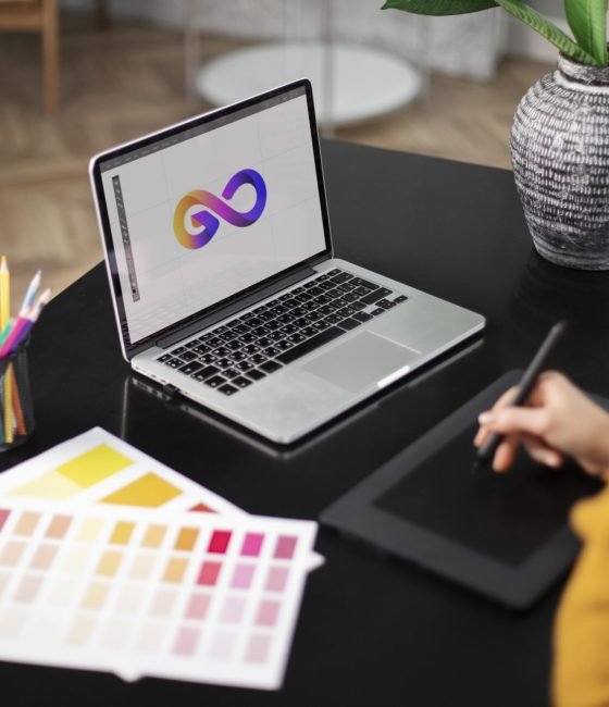 female-logo-designer-working-her-tablet-connected-laptop